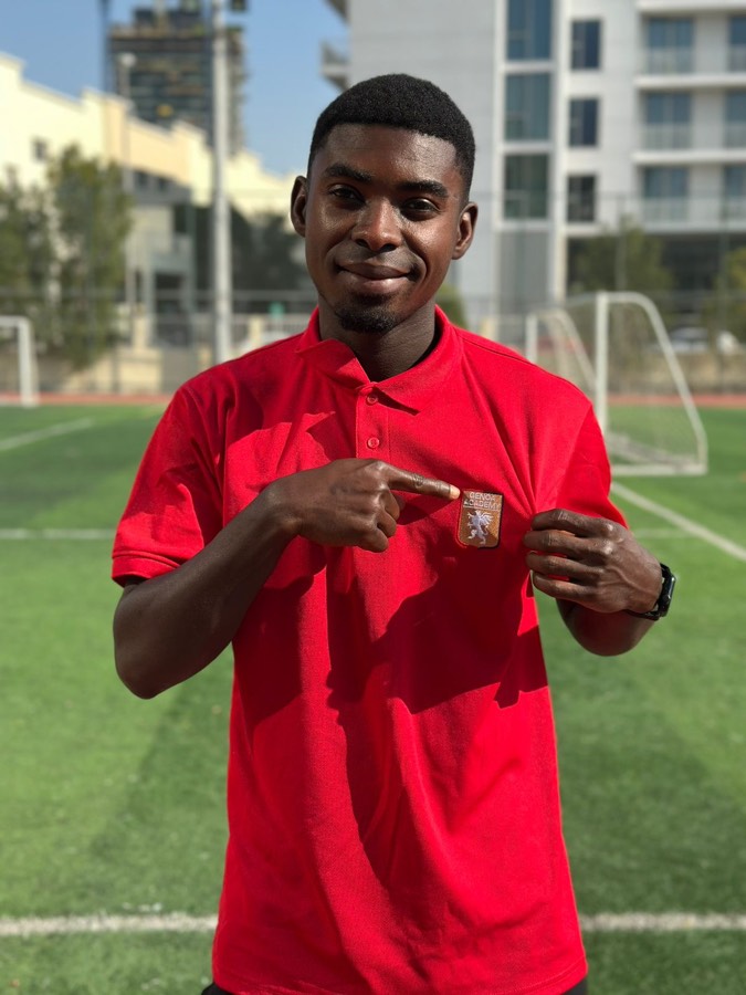 Genoa Academy coach in red polo