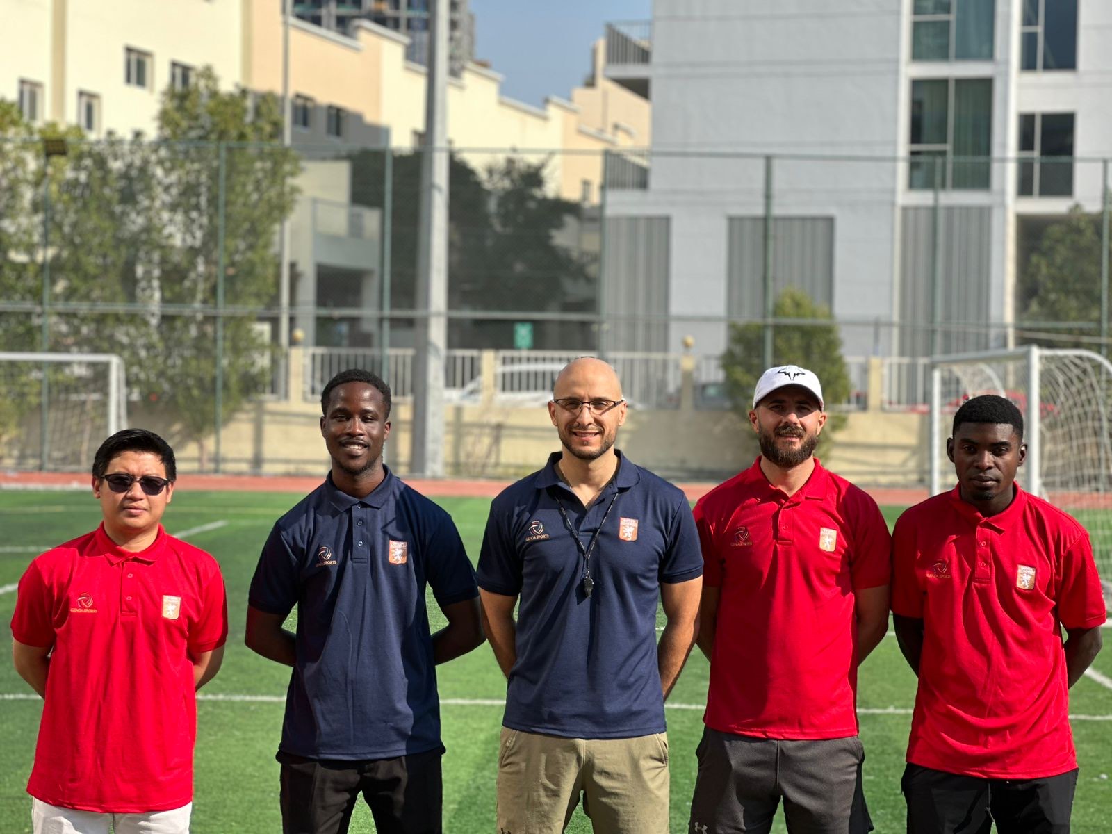 Genoa Academy UAE coaching staff lined up on the pitch